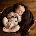 Newborn baby with father's military dog tags