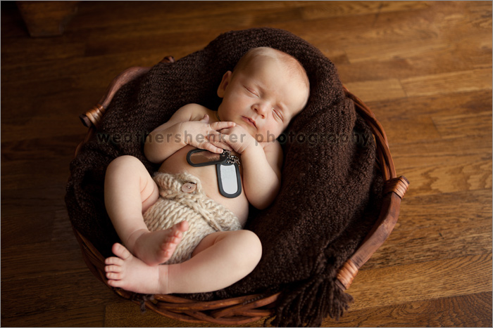 Newborn baby with father's military dog tags