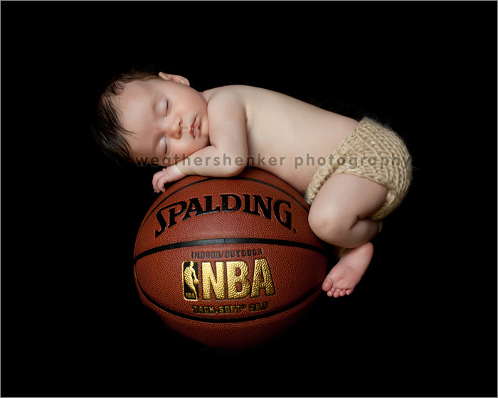 Newborn baby girl on basketball photograph